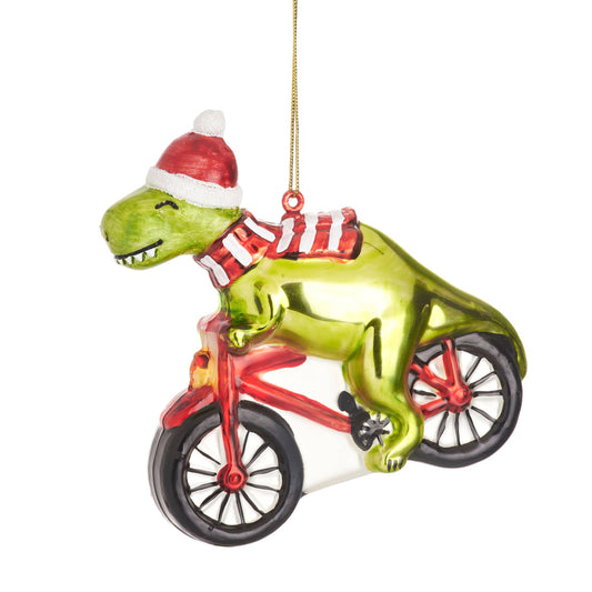 Boule de Noël dinosaure sur un vélo