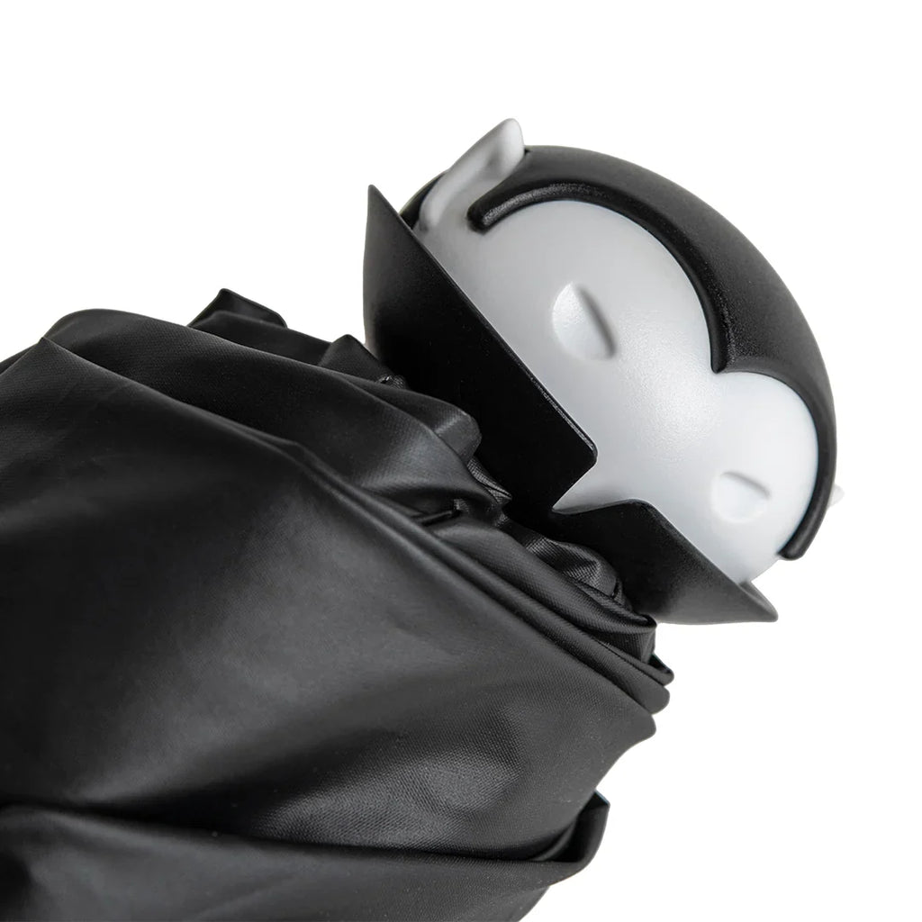 Spookula: A black-and-white vampire figure with closed eyes, wrapped in black cloth.